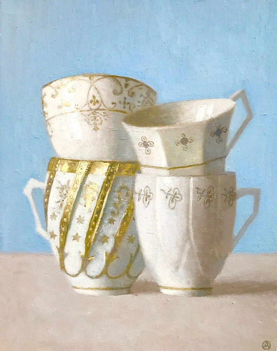 Four White and Gold Cups on Blue